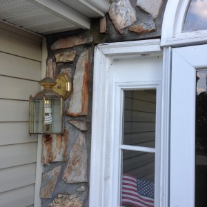 Closeup photo of door Frame damage from lack of roof flashing in Stone Veneer in Charlotte, NC