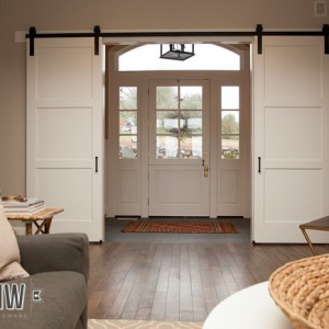 Interior sliding barn doors used to help flow traffic through front door