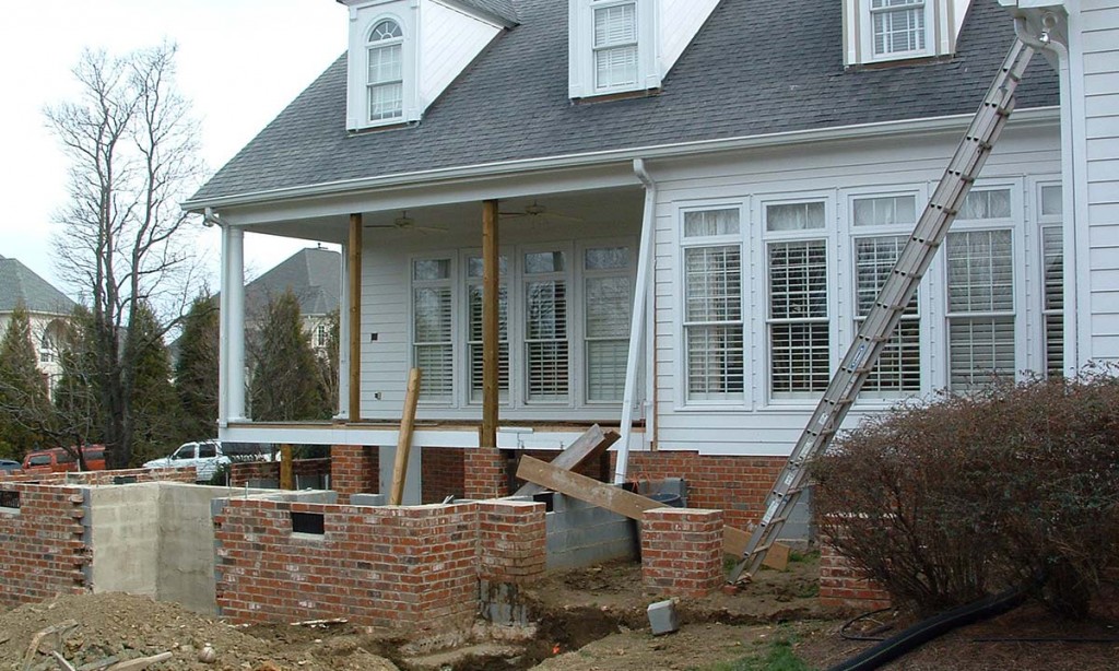 Exterior photo of home addition during construction and laying of the foundation