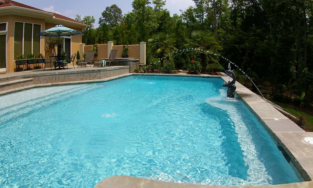 Charlotte pool house builder and pool builder with outdoor patio area