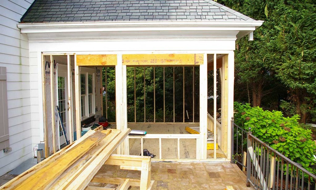 Construction photo showing sunroom being completely re-engineered and reframed for the space