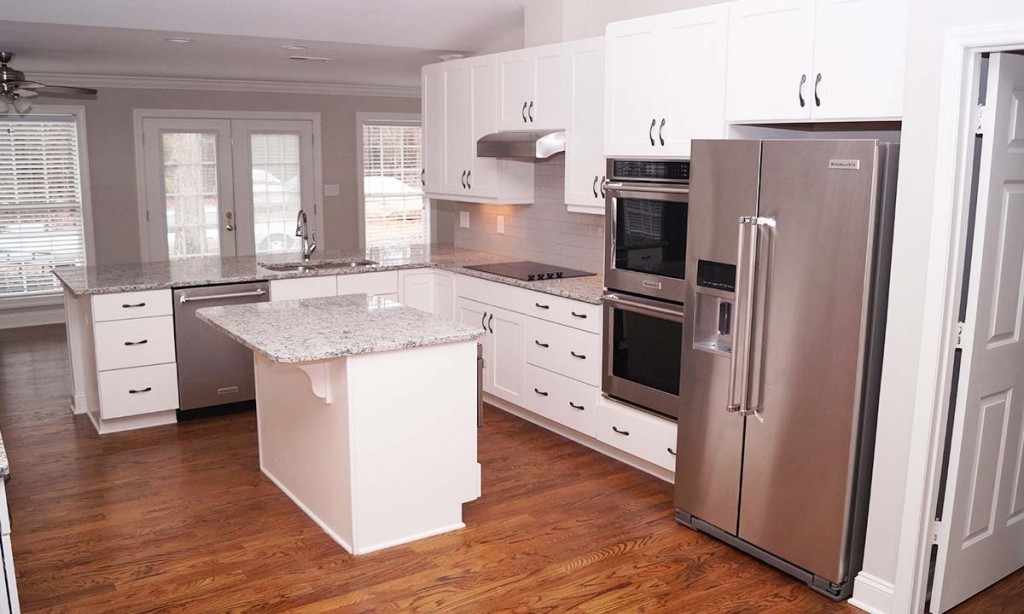 New kitchen features granite countertops, stainless steel appliances and a large island for workspace and seating