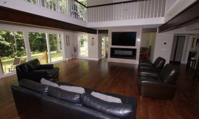 living room remodel with TV above fireplace