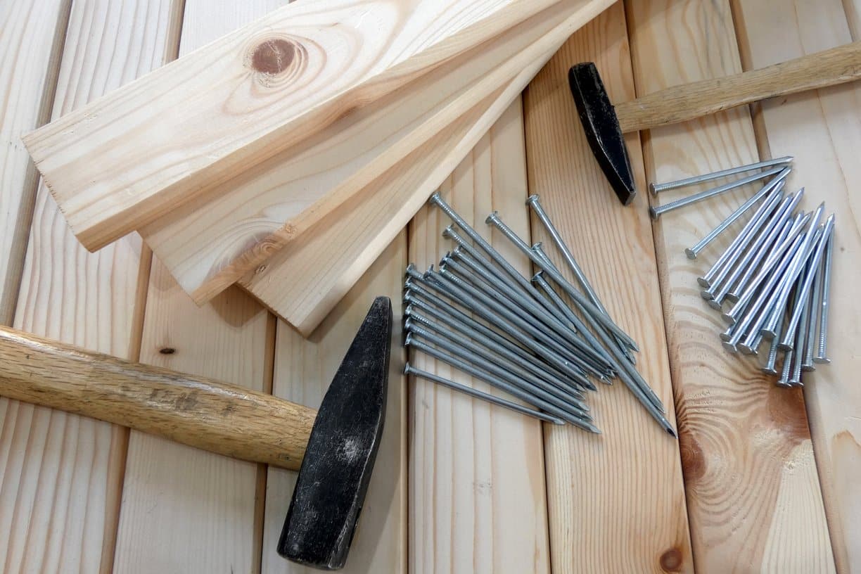 carpentry image with wood, nails, and hammer
