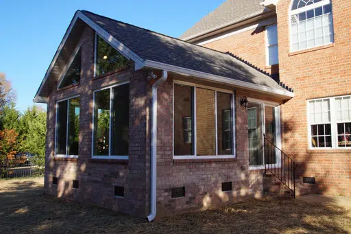 exterior photo of brick enclosed sunroom addition