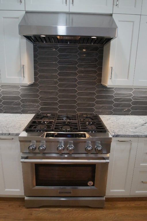 kitchen remodel with range stove and gray tile backsplash
