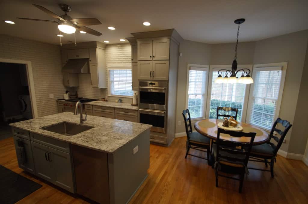 updated kitchen with island and granite countertops