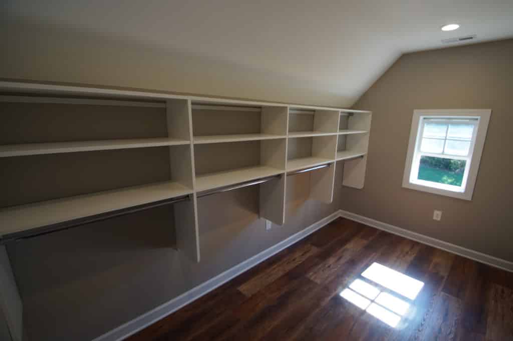 after image of finished attic converted to closet with rods
