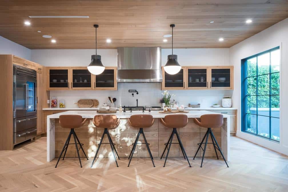 long kitchen island with natural colored cabinets