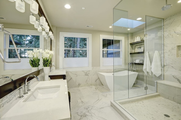 framless shower in marble bathroom