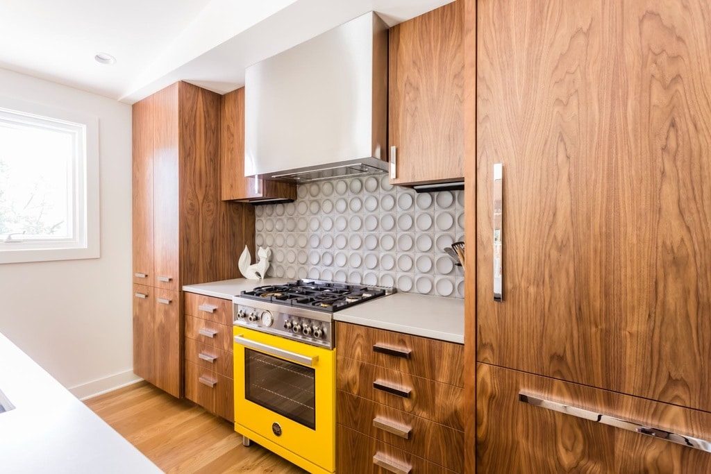kitchen remodeling with yellow oven and wooden cabinets