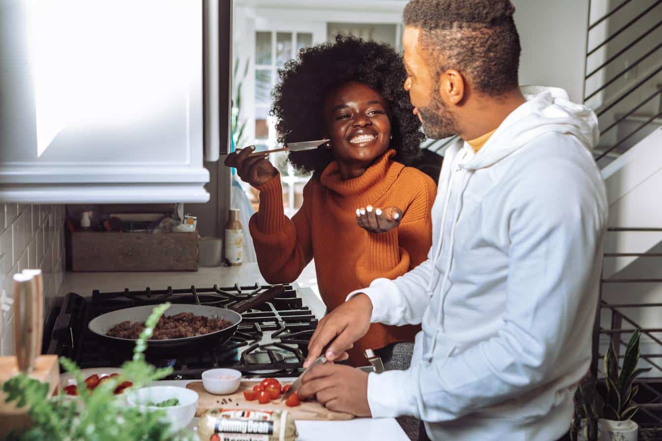 couple cooking over the stove