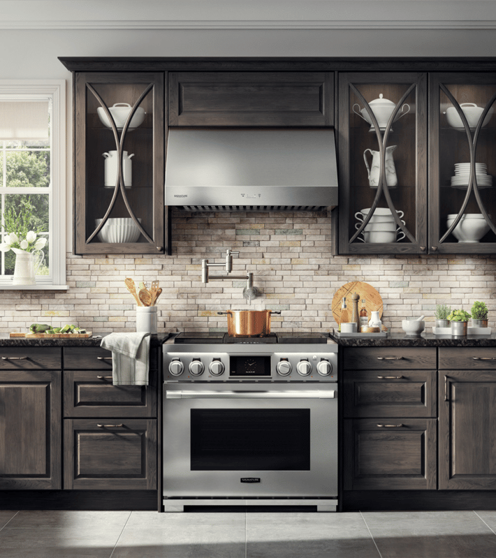 dark kitchen cabinets with a stove top oven
