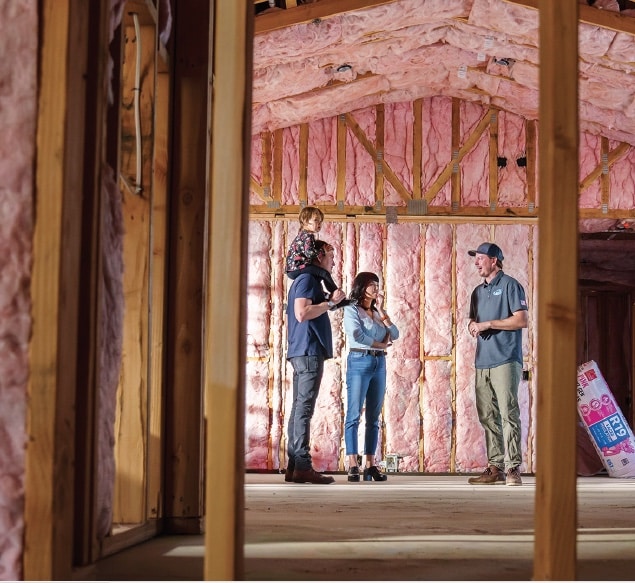a family viewing insulation installation during the remodel process