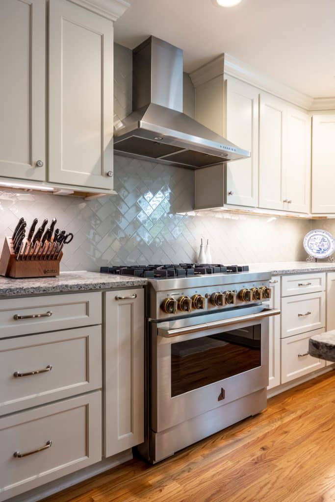 after photo of kitchen remodel focused on gas range stove top oven with hood