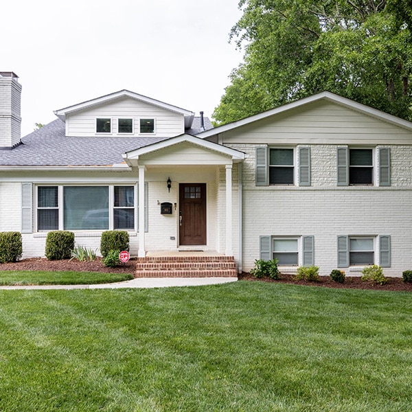 exterior remodel with white brick and covered entryway