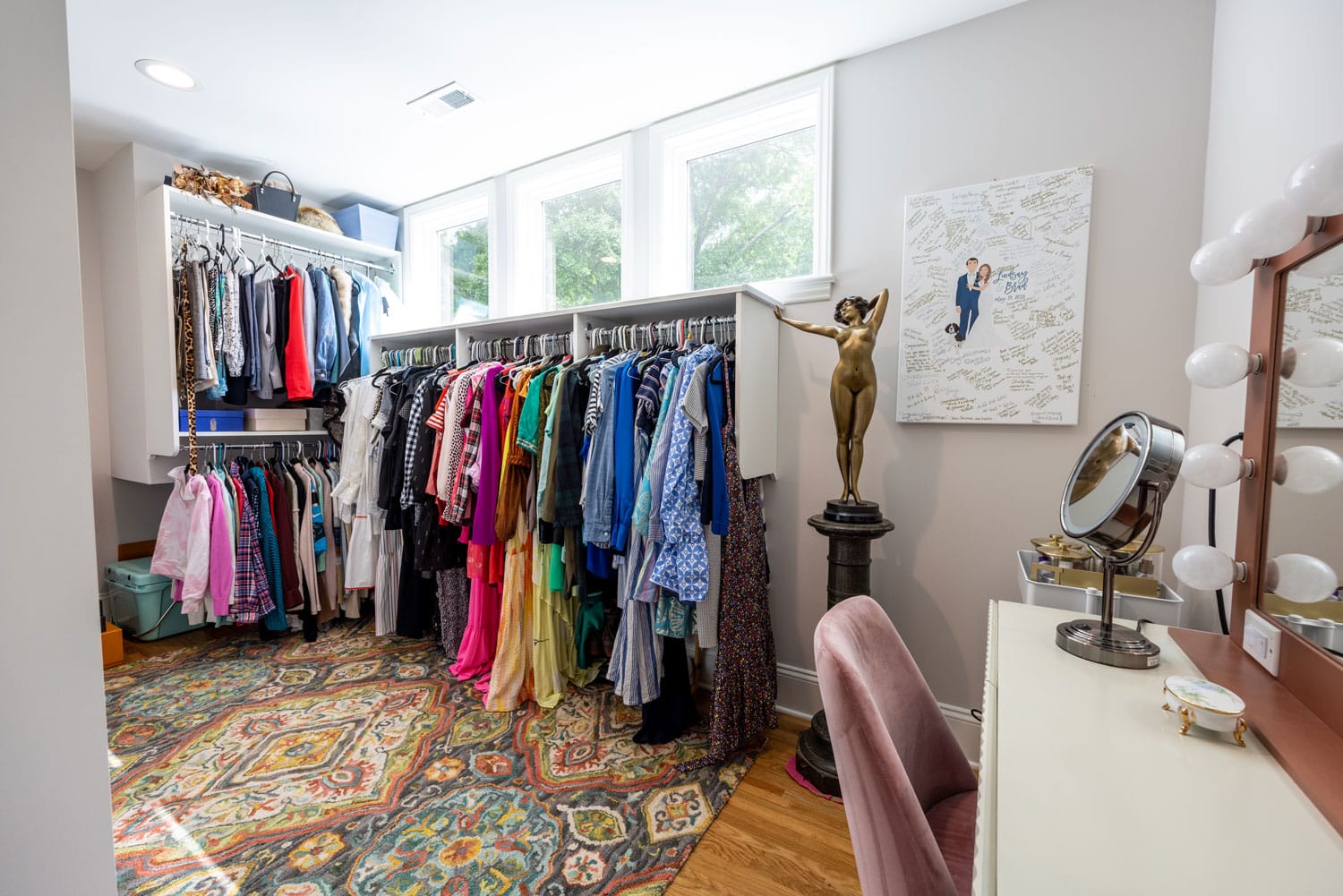 primary bedroom walk-in closet with vanity