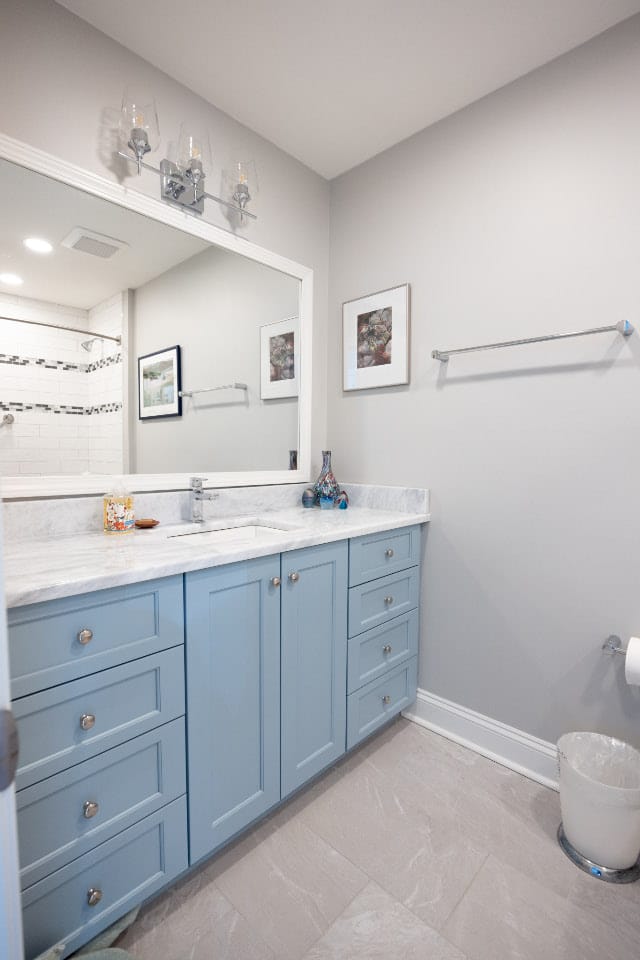 updated bathroom with blue cabinets