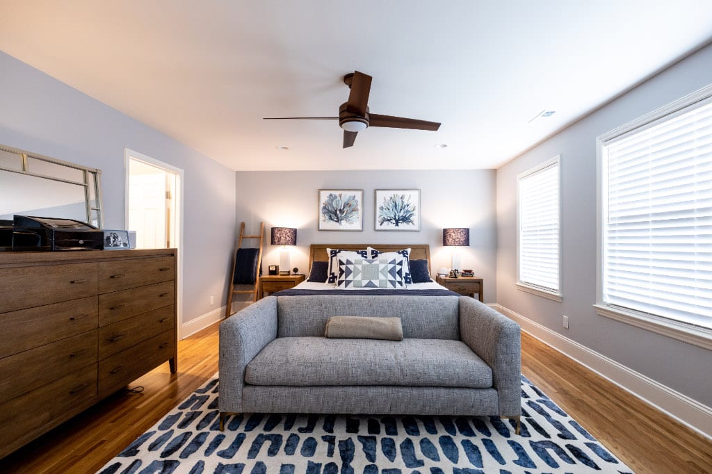 primary bedroom with queen bed and sofa