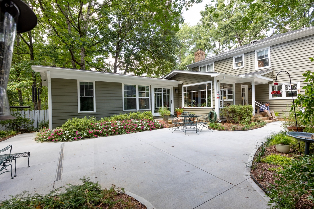 exterior of primary bedroom addition with manicured patio