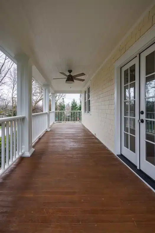 covered porch with ceiling fan and wood floors