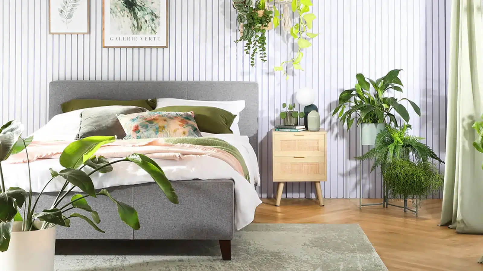 primary bedroom with earth tones and green plants for decor