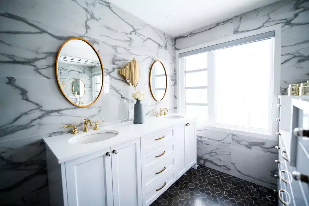 white and gray bathroom with gold accents