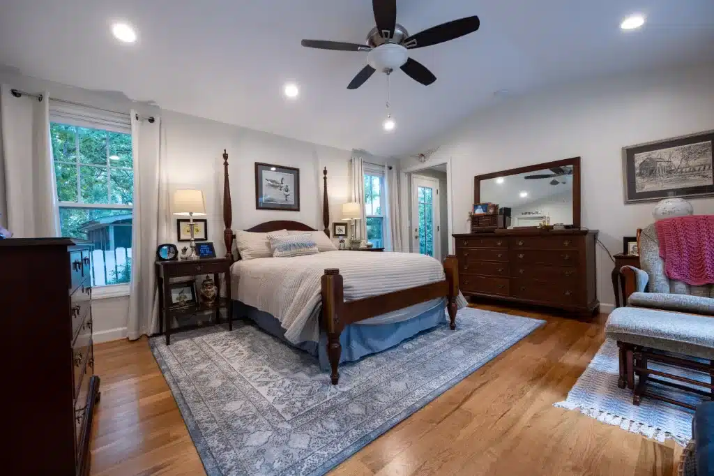 primary bedroom in ADU with modern ceiling fan and hardwood floors