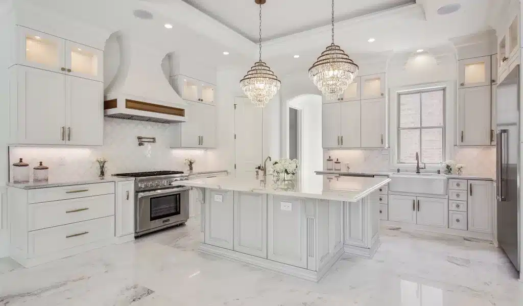 white kitchen with large center island and range stove oven