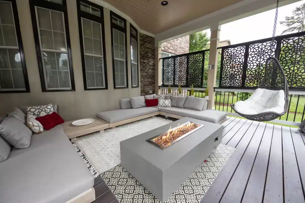 modern fire pit in back covered porch remodel surrounded by outdoor couches