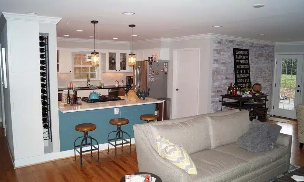 kitchen remodel in 1960s renovated brick ranch home with peninsula bar in between kitchen and living room