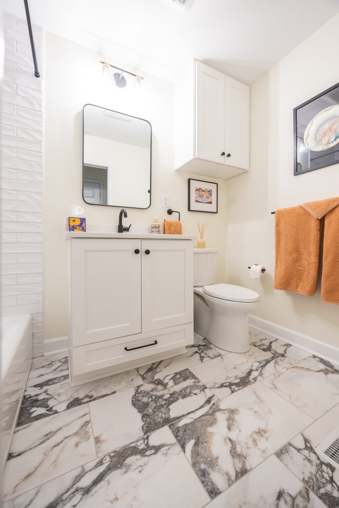 white and gray marble bathroom with white subway tiles