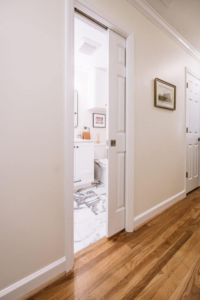 Hallway with cohesive paint and flooring connecting rooms