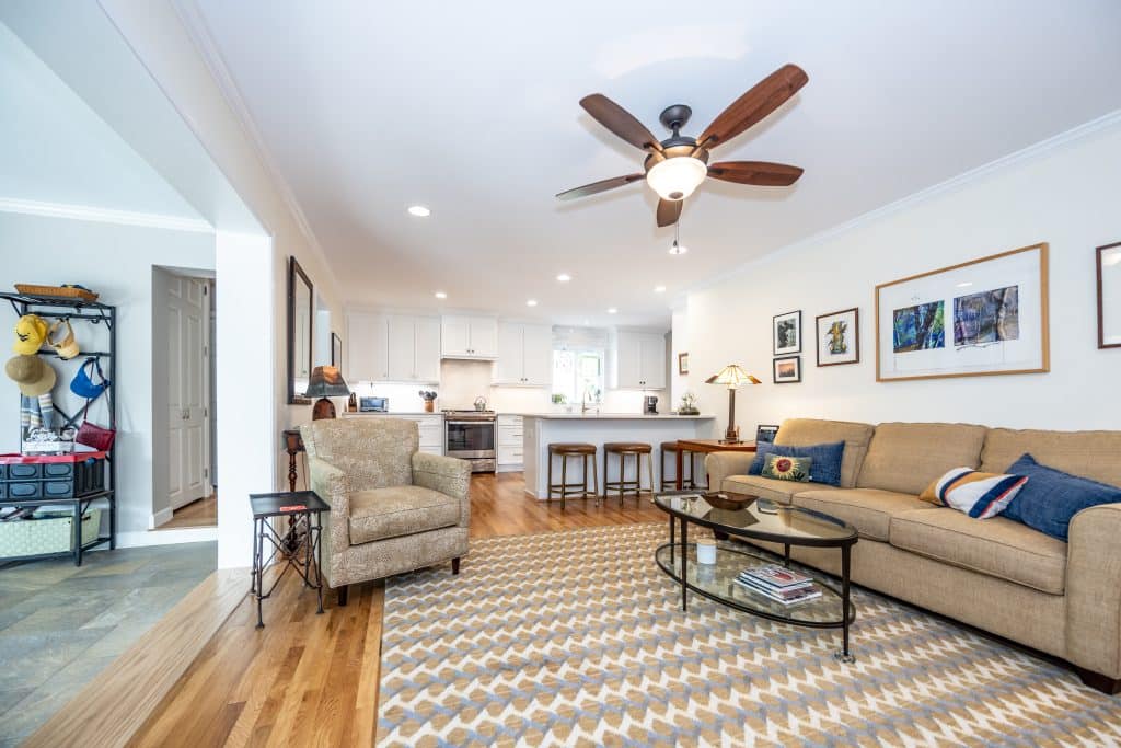 living room with wood floors and ceiling fan