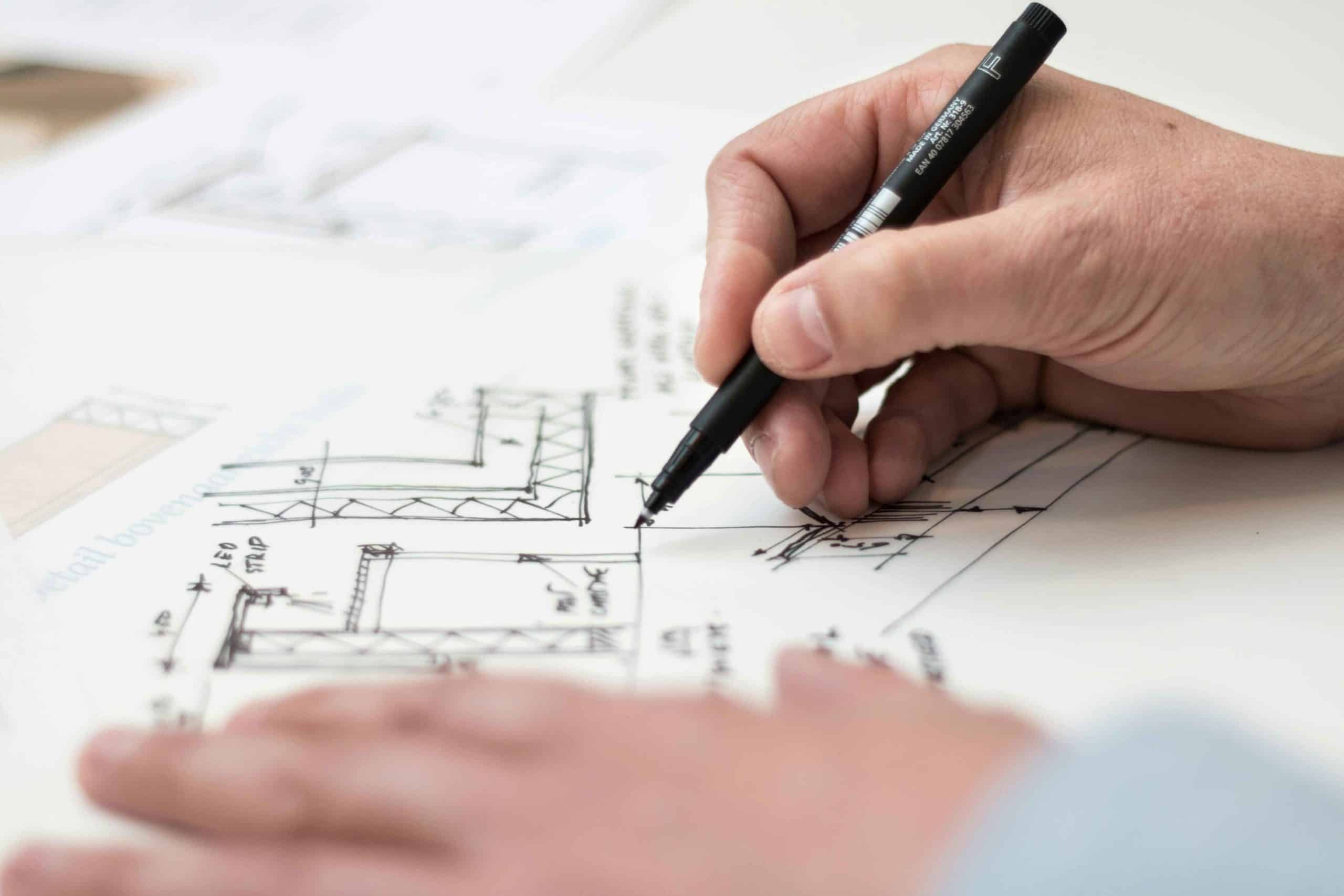 contractor drawing plans on paper