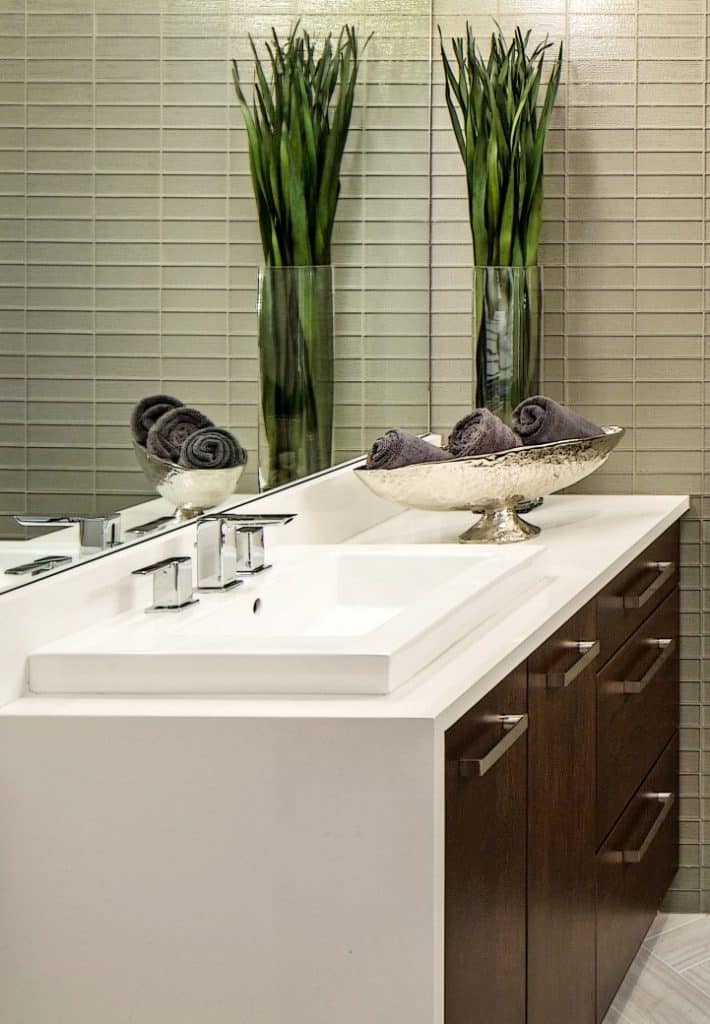 guest bathroom with single sink and silver tray with towels