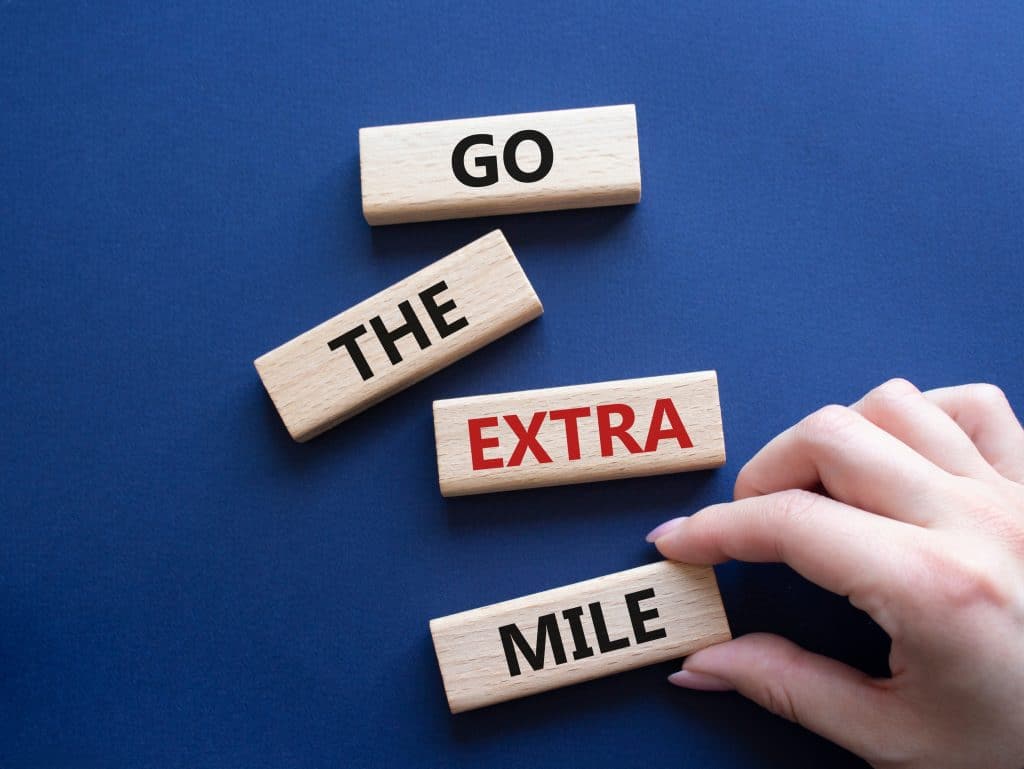 wood blocks with words go the extra mile