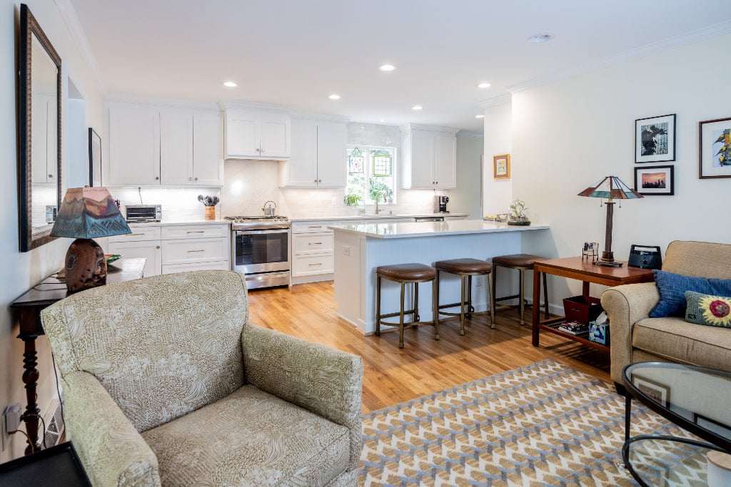 remodeled kitchen that opens up to living room - divided by a peninsula countertop and bar stools