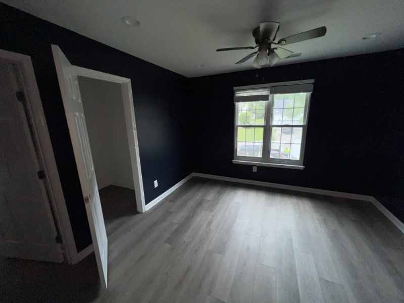 flex room with storage closet that could be used for bedroom or home office with window and ceiling fan
