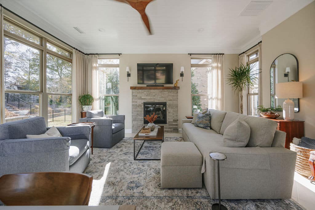 sunroom with fireplace, dining table, and lounge area with couches