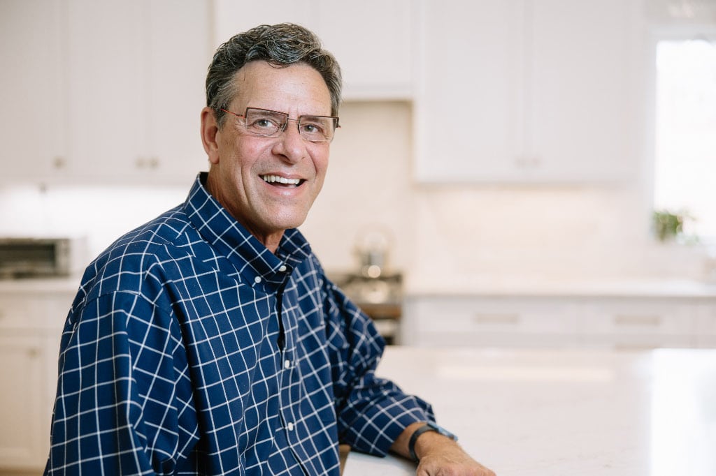 gary palmer smiling iin newly remodeled kitchen