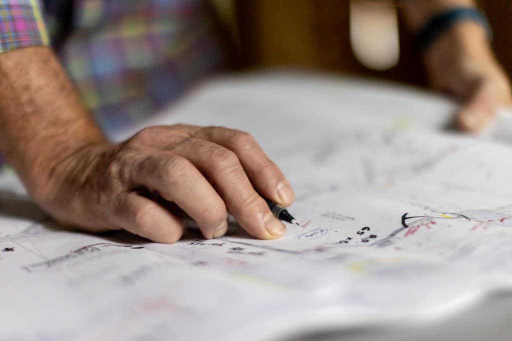 a hands tracing construction plans