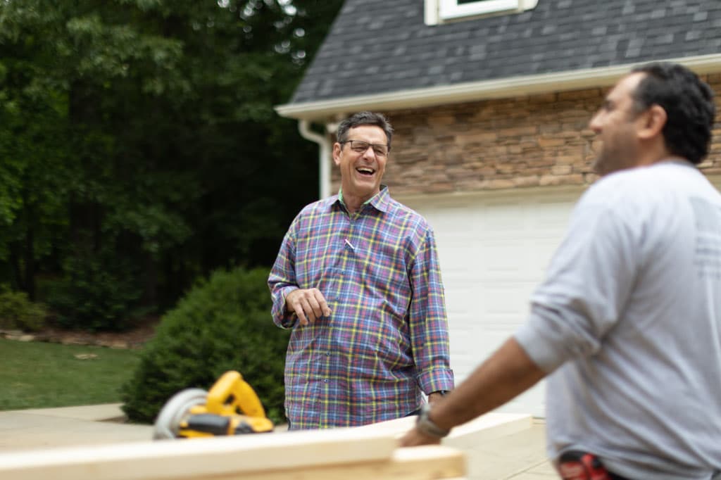 gary palmer outside smiling with a contractor
