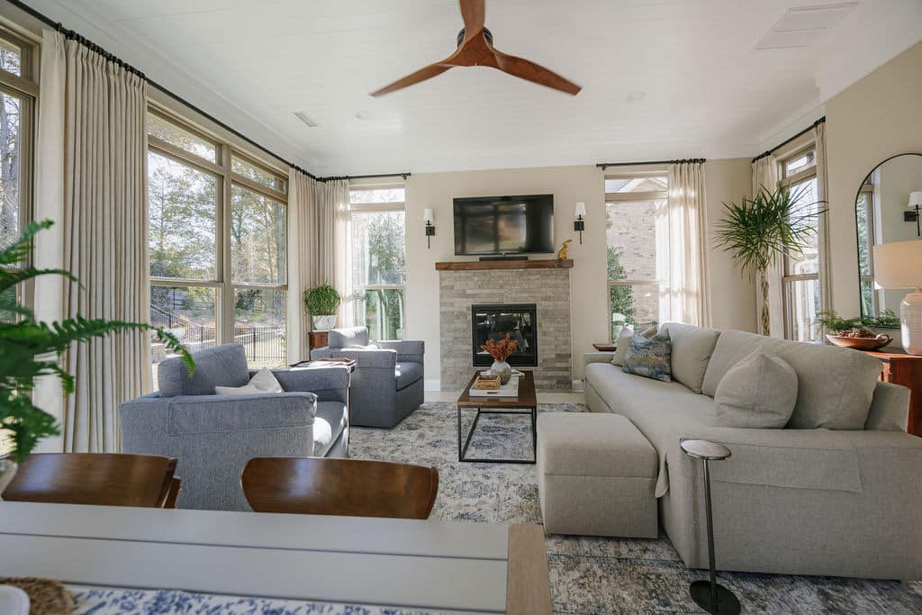 natural stone fireplace with wood mantel with cozy couches