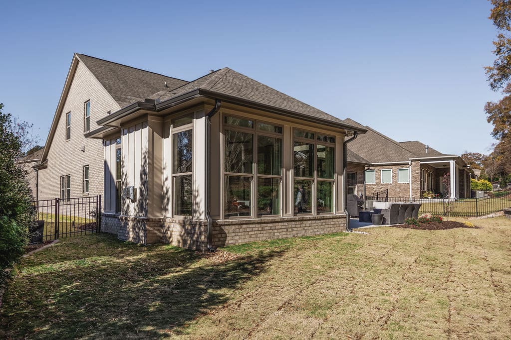 exterior of sunroom remodel with laarge windows on all 3 sides