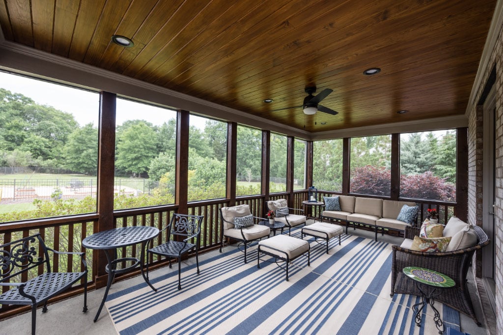 screened in porch with rug and couch seating