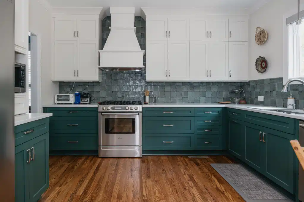 green kitchen bottom cabinets with white upper cabinets and open middle area with wood floors