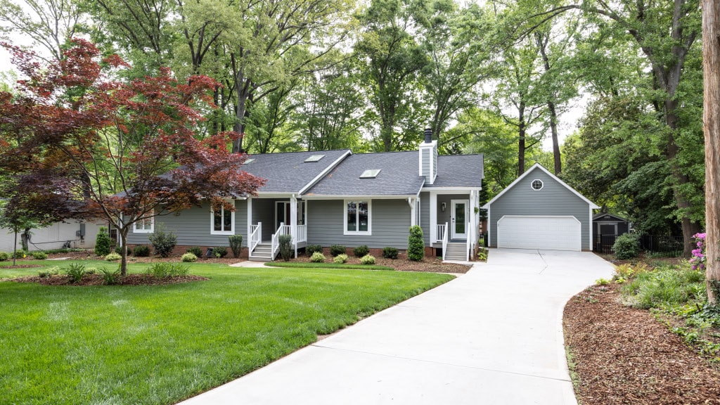 ranch style home remodel with wooded area in back of house