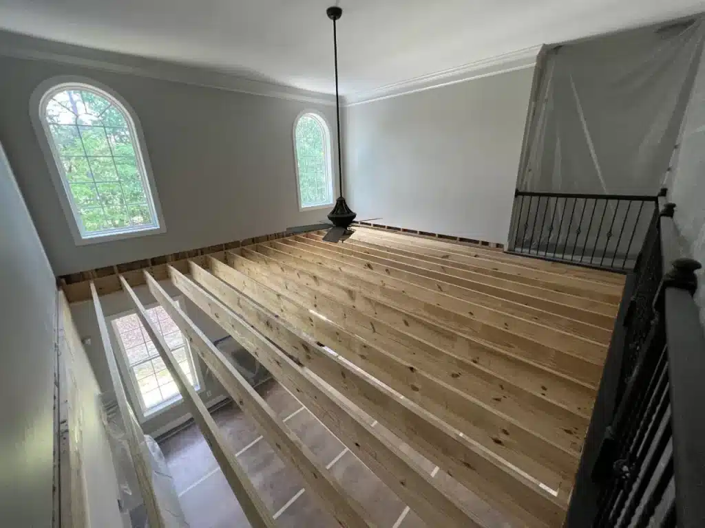 in-progress floor over construction project with wood plans creating additional second floor functional space
