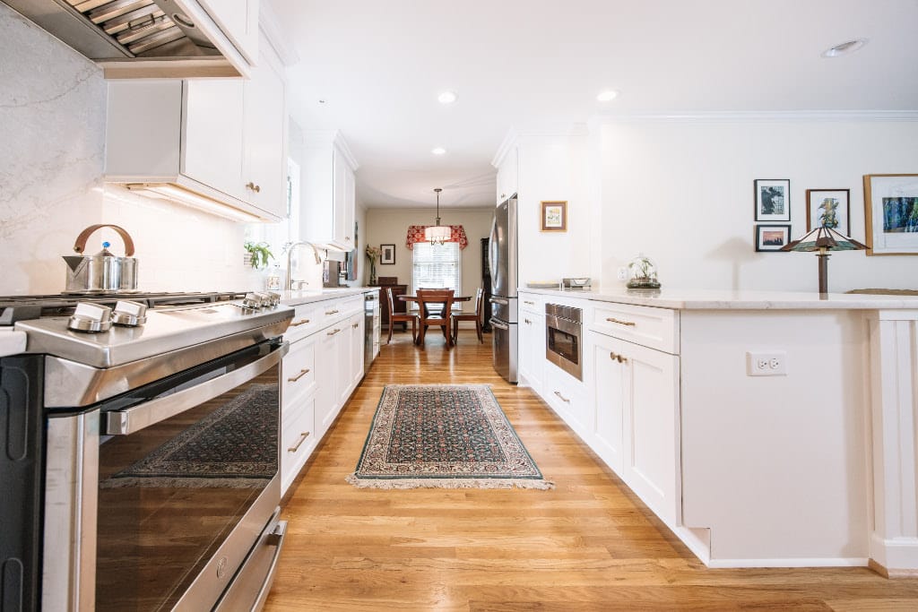 peninsula island kitchen with hallway connecting kitchen and formal dining